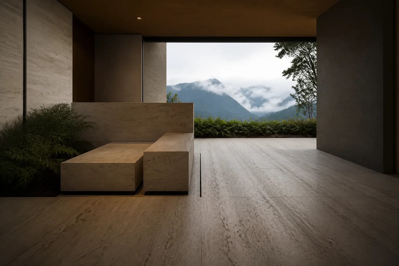 Interior de travertino con banca monolítica y vista a la montaña